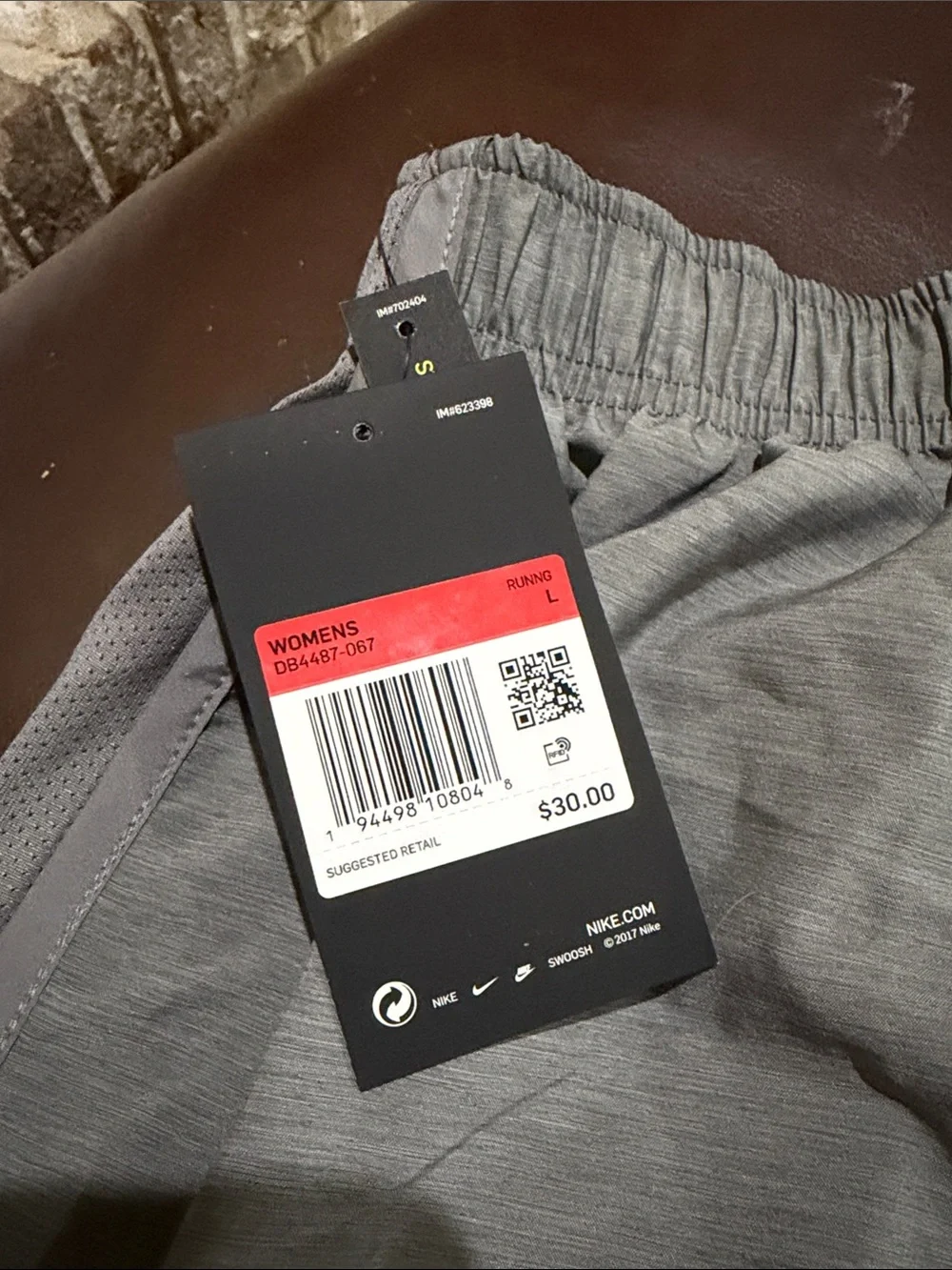 Nike Women's Light Gray Athletic Shorts with Swoosh